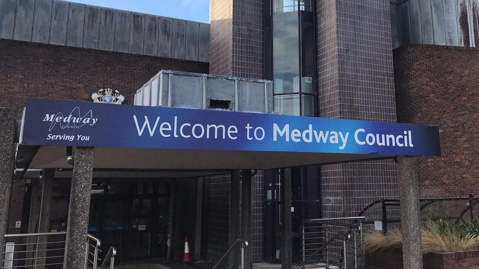 A blue sign outside the front of a brick building. It reads "Welcome to Medway Council".