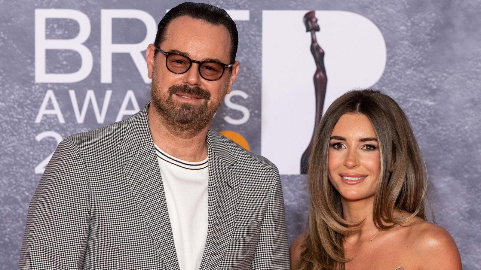 Danny and Dani Dyer posing on the Brit Awards 2025 red carpet
