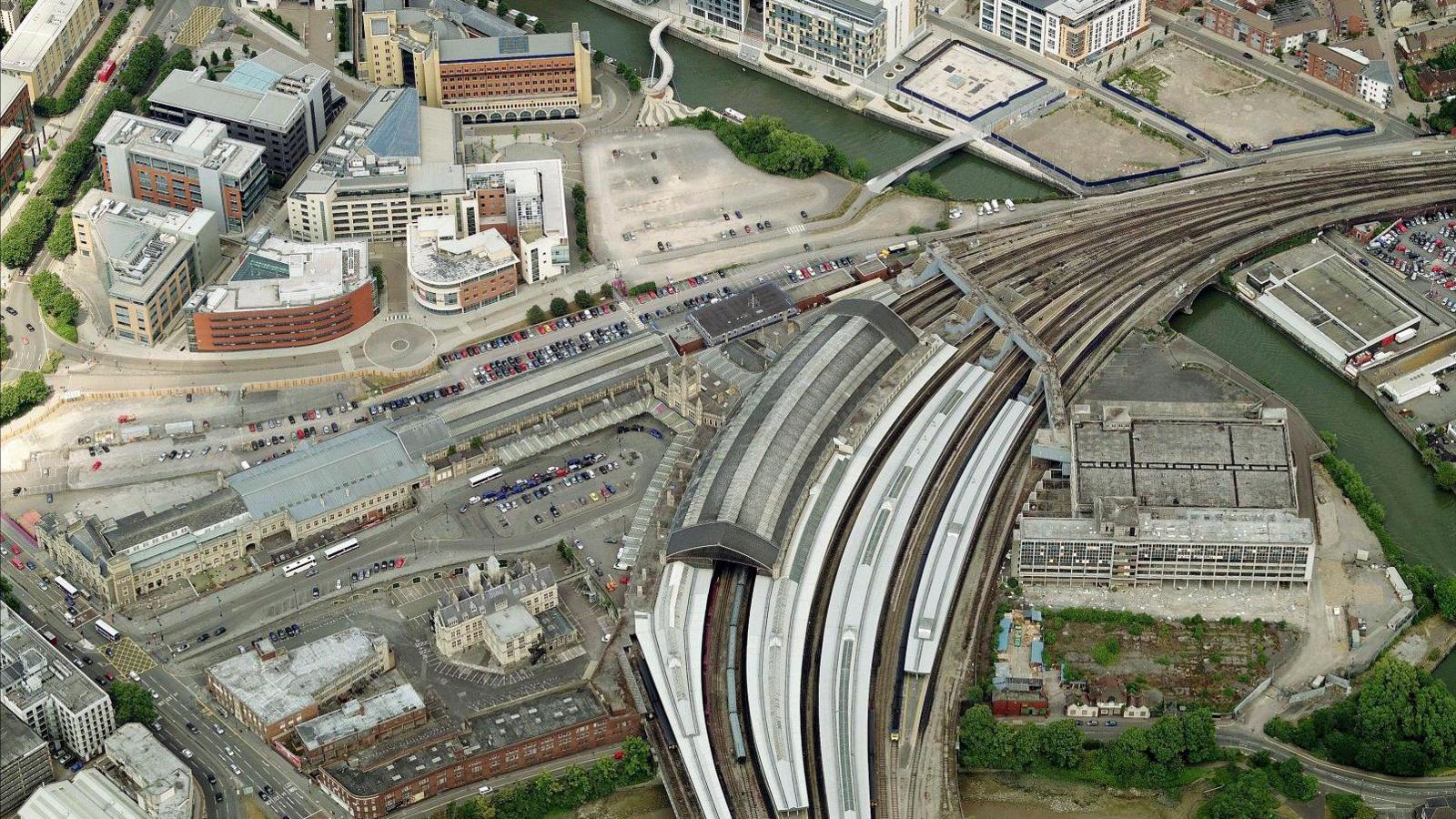 An aerial shot of Bristol Temple Meads showing the rail lines going in to the station and nearby pedestrianised areas and office blocks