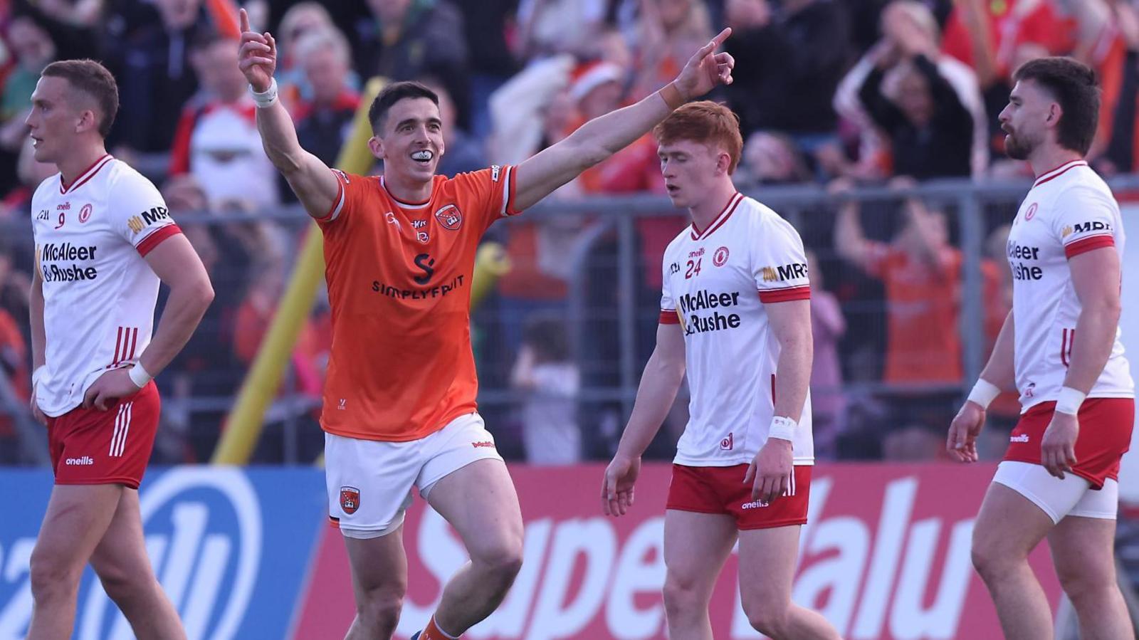 Armagh's Rory Grugan celebrates after kicking his match-winning free as Tyrone's Conn Kilpatrick, Seanie O'Donnell and Padraig Hampsey show their dejection