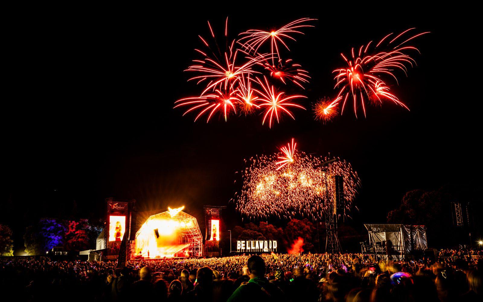 Vivid firework display over the stage and crowd on the final evening of the festival