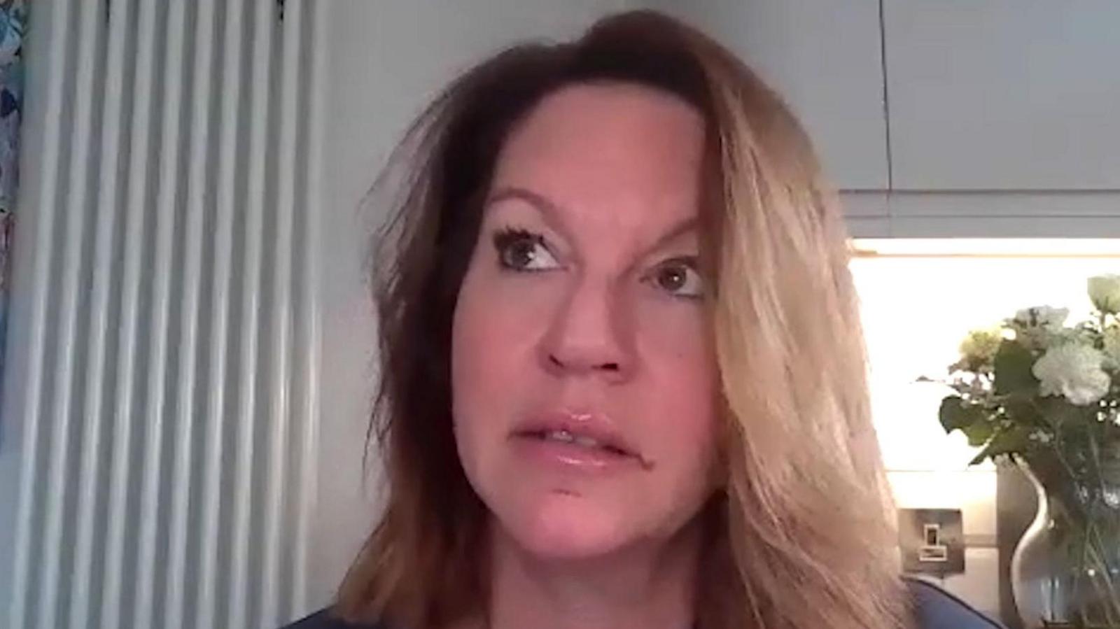 Emma Webber, with long light brown hair, looks to the side of the camera as she is being interviewed.