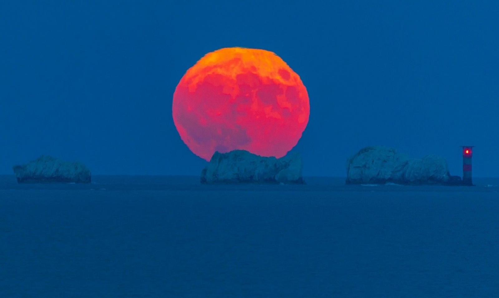 The full Strawberry Moon rising over the Needles