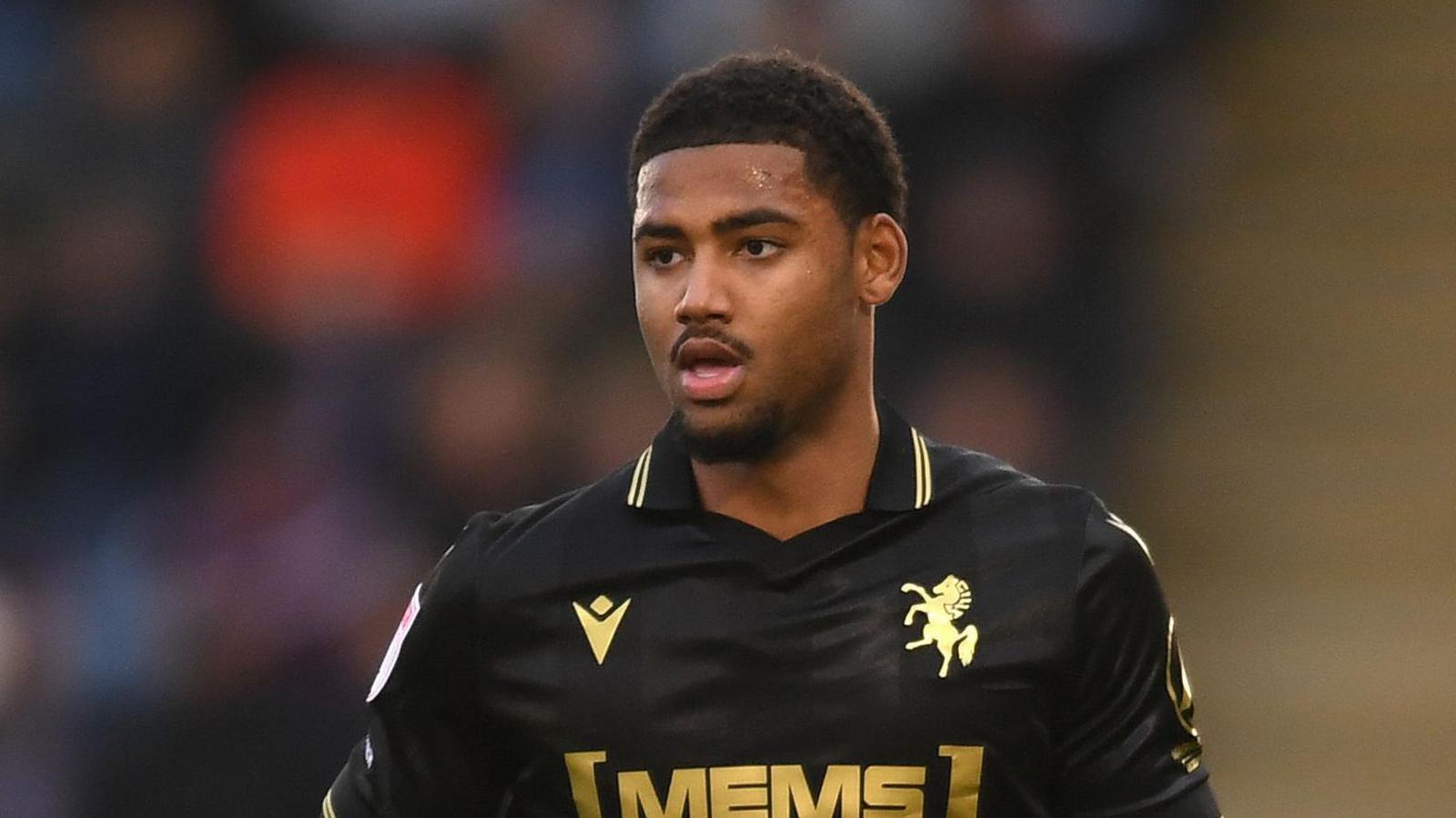 Travis Akomeah running on the pitch during a game for Gillingham