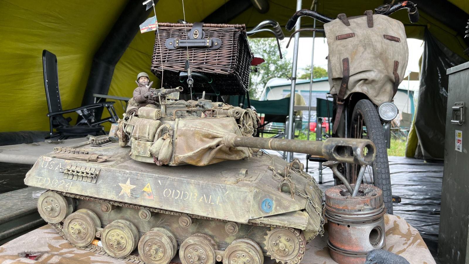 A small model of a tank amongst items being used to display at the event