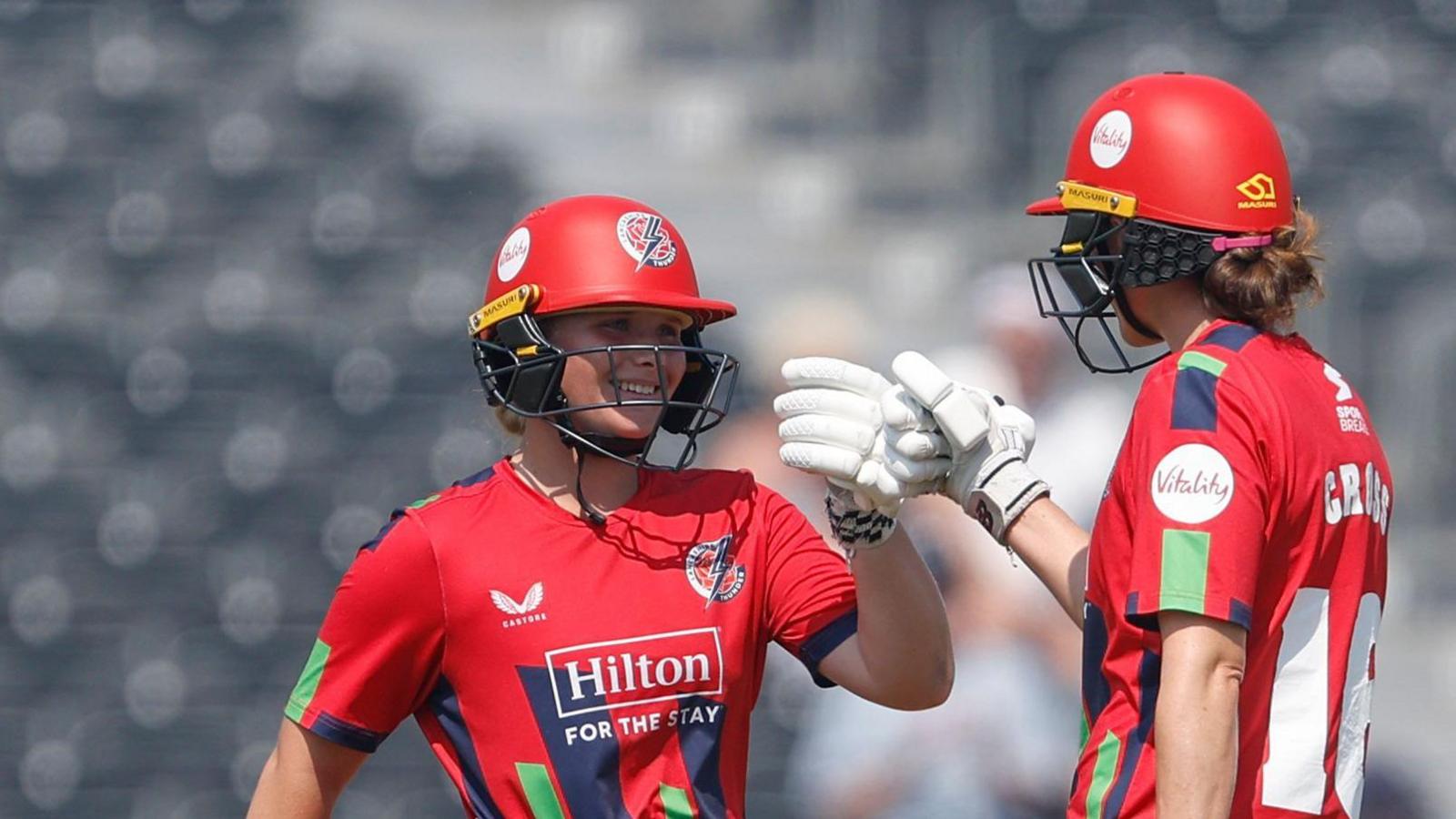 Skye Thomas (left) and Kate Cross punch gloves during their unbroken partnership in Lancashire's T20 Blast win over Durham