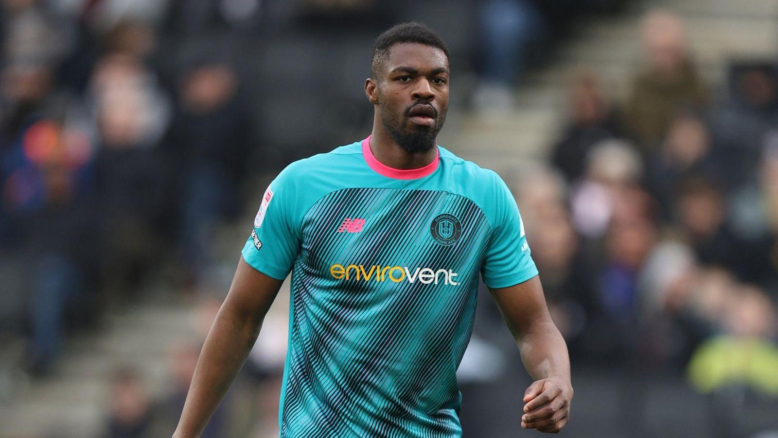 A photo of Emile Acquah, wearing a light blue Harrogate Town kit, during the side's game against MK Dons in March
