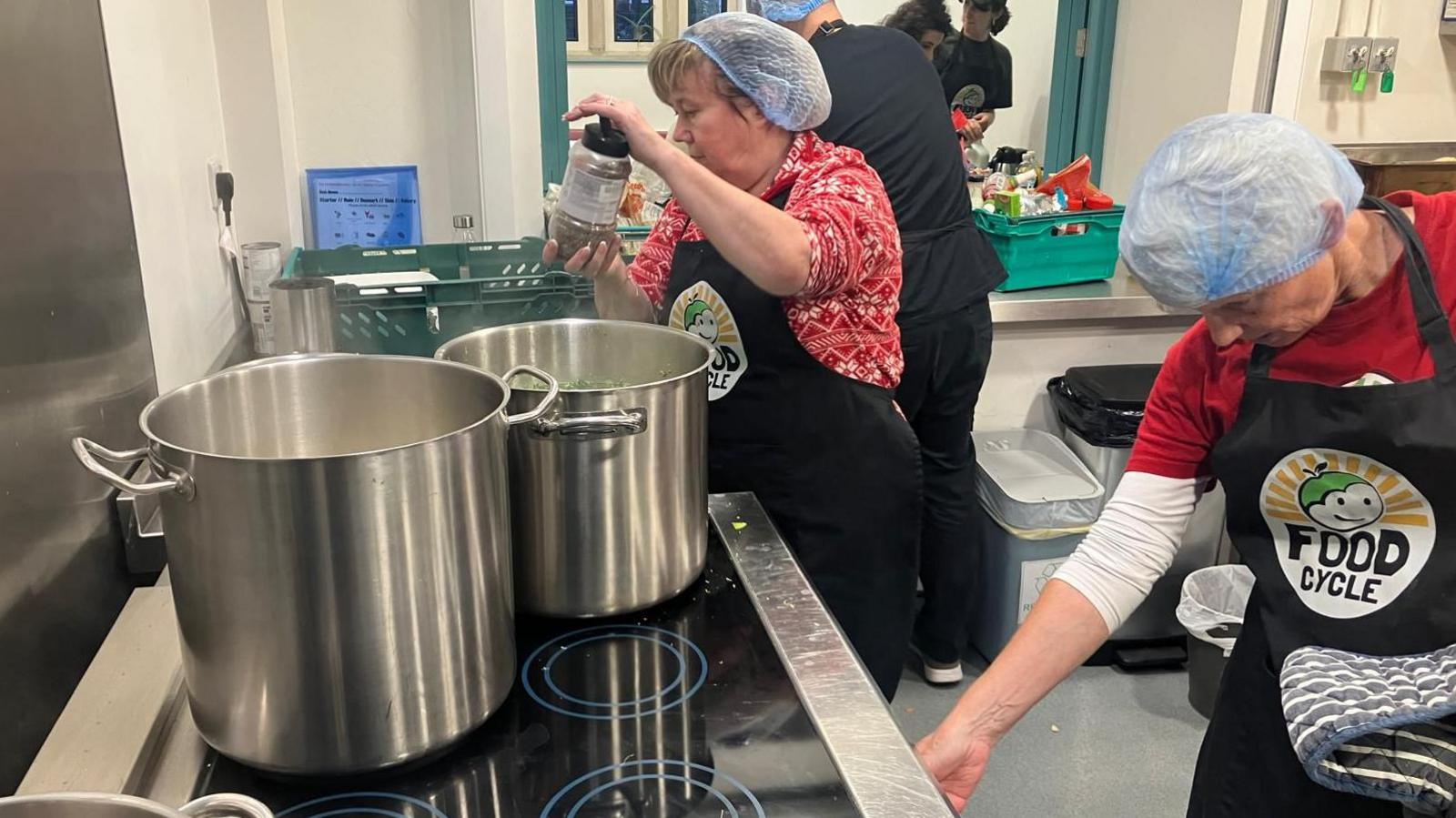 FoodCycle volunteers at St Lukes, Leeds, cooking in a kitchen for guests