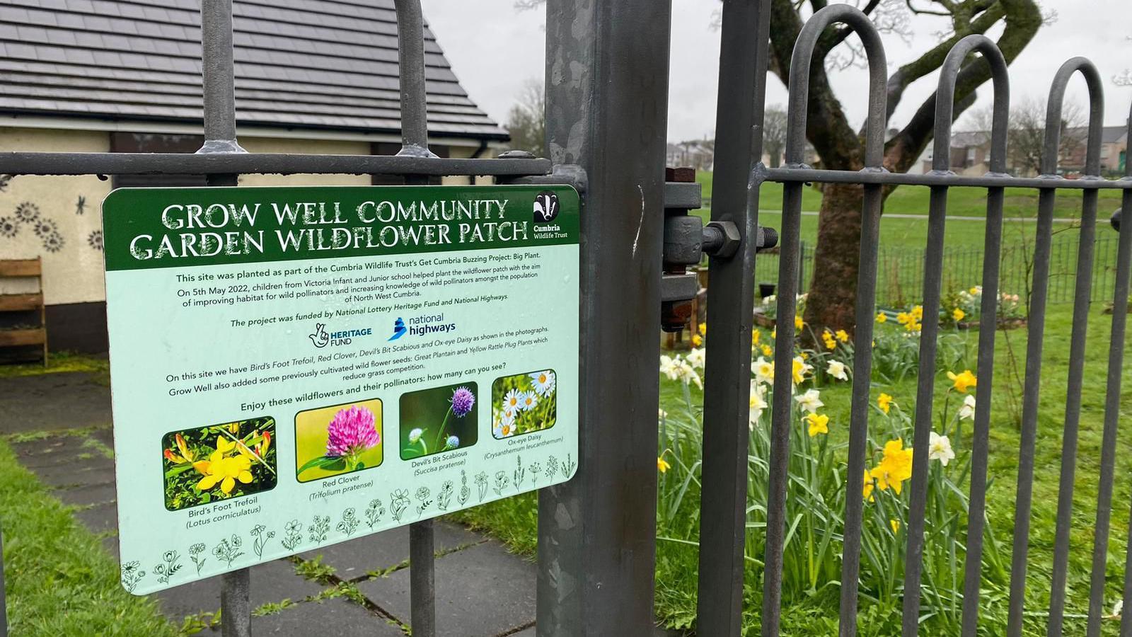 Signage for garden with plants in the background