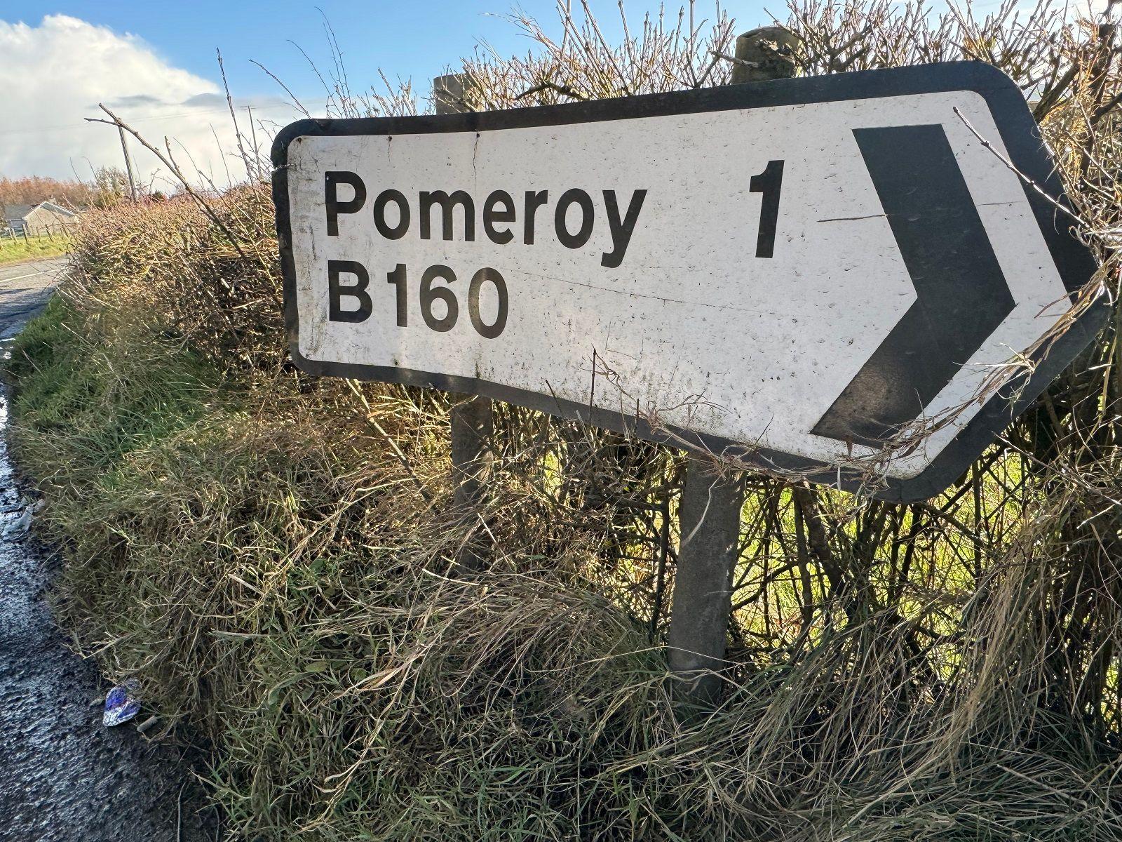 A white NI road sign which says Pomeroy 1, B160.