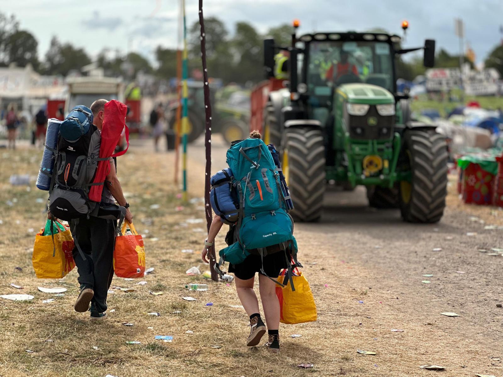 People leave the Glastonbury site