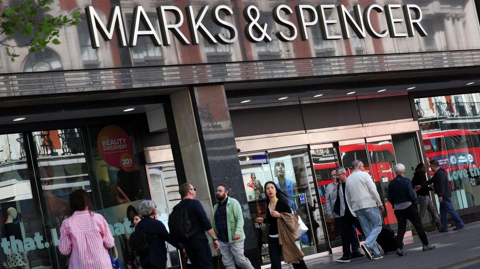 People walking past a Marks & Spencer store