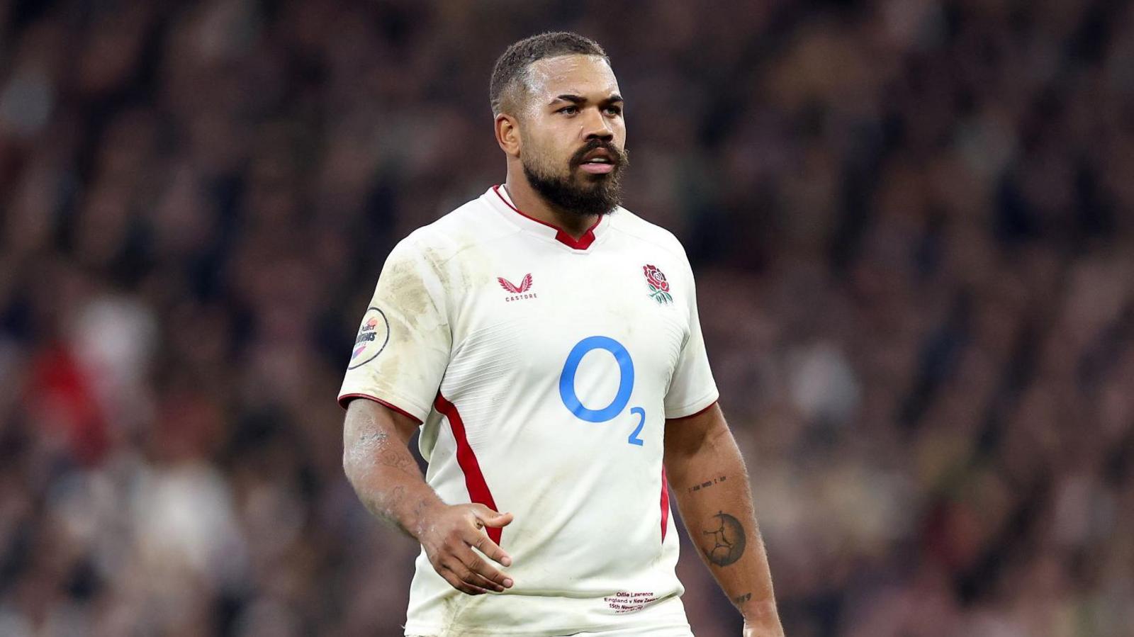 Ollie Lawrence standing on the pitch at the Allianz Stadium during a match for England