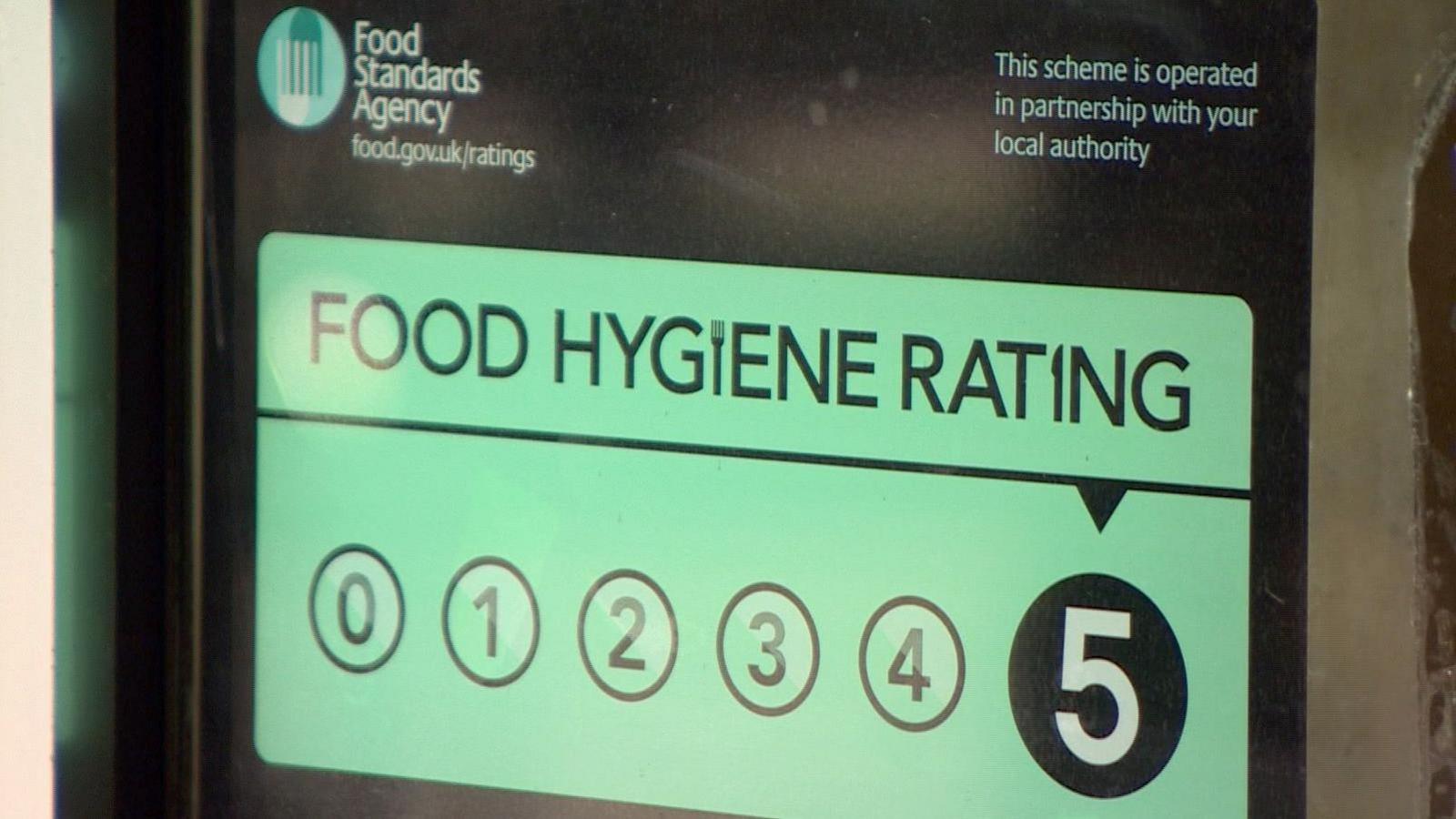 A Food Standards Agency rating scheme sticker on the outside of an outlet serving food