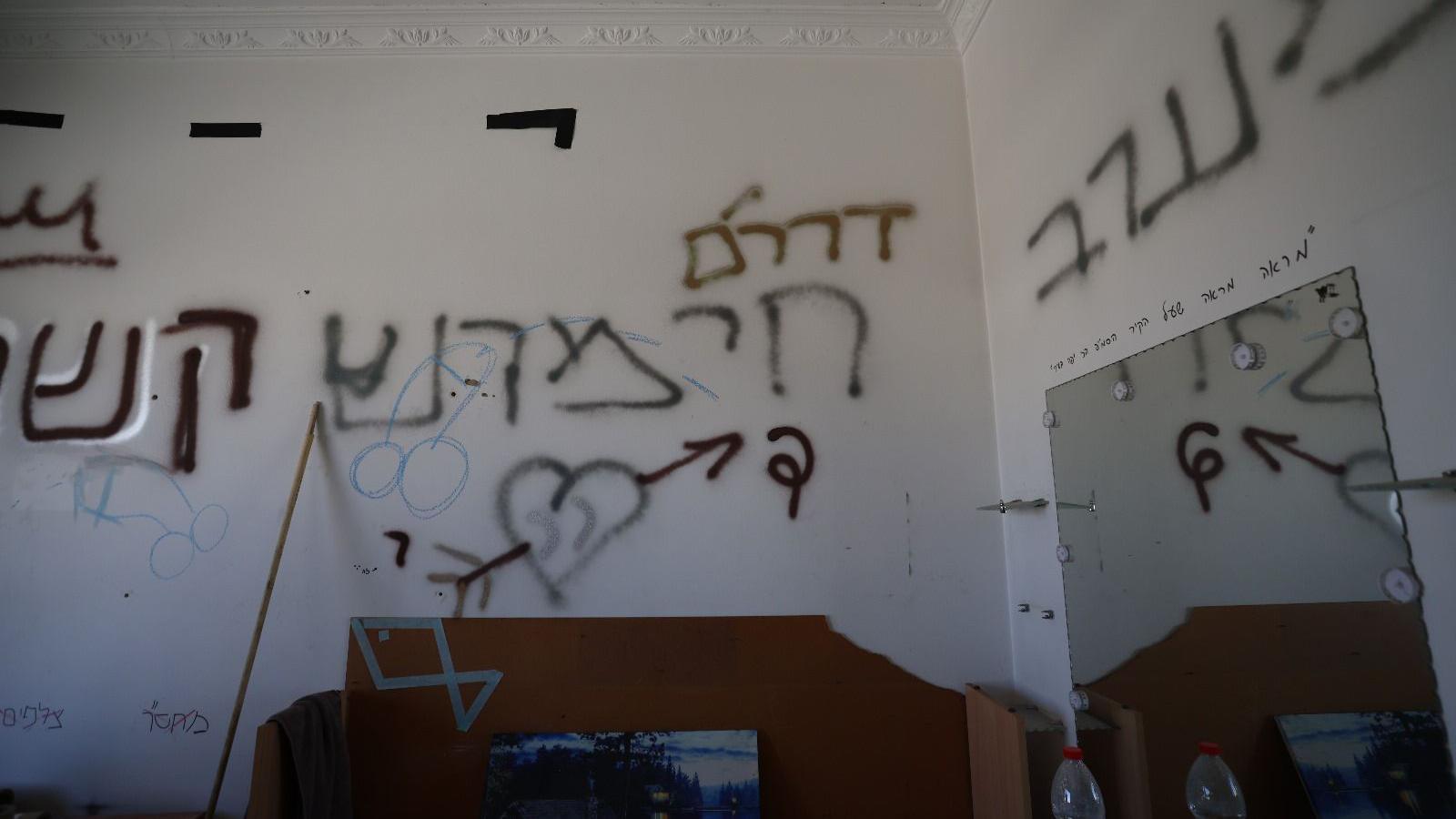 Graffit on walls inside an apartment includes lewd images of penises