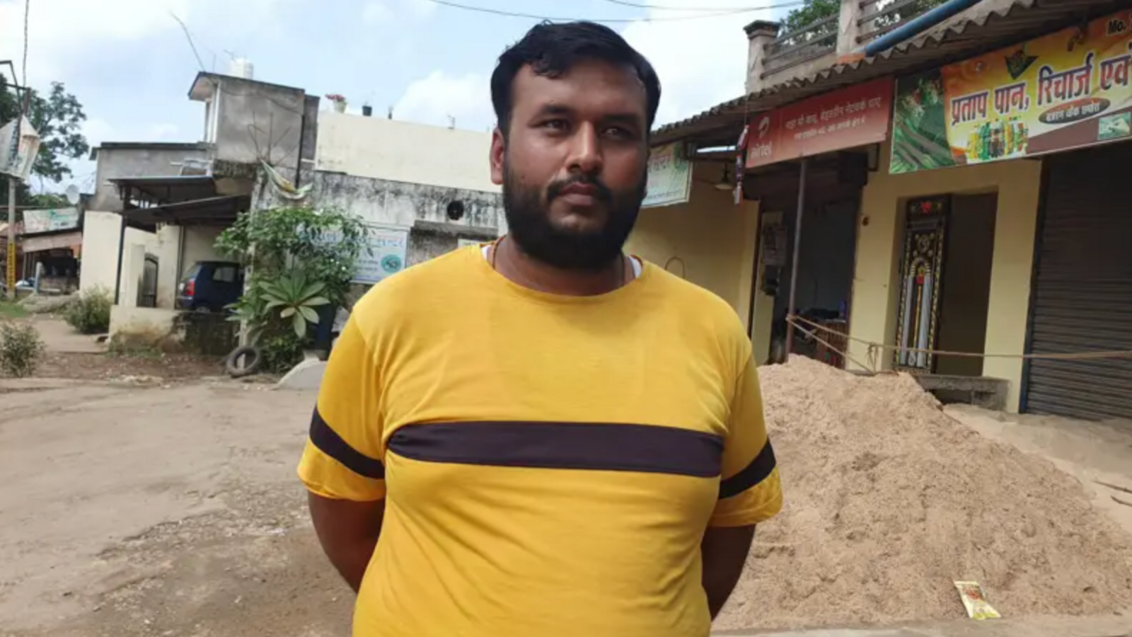 Ajay Agarwal standing in front of village shops