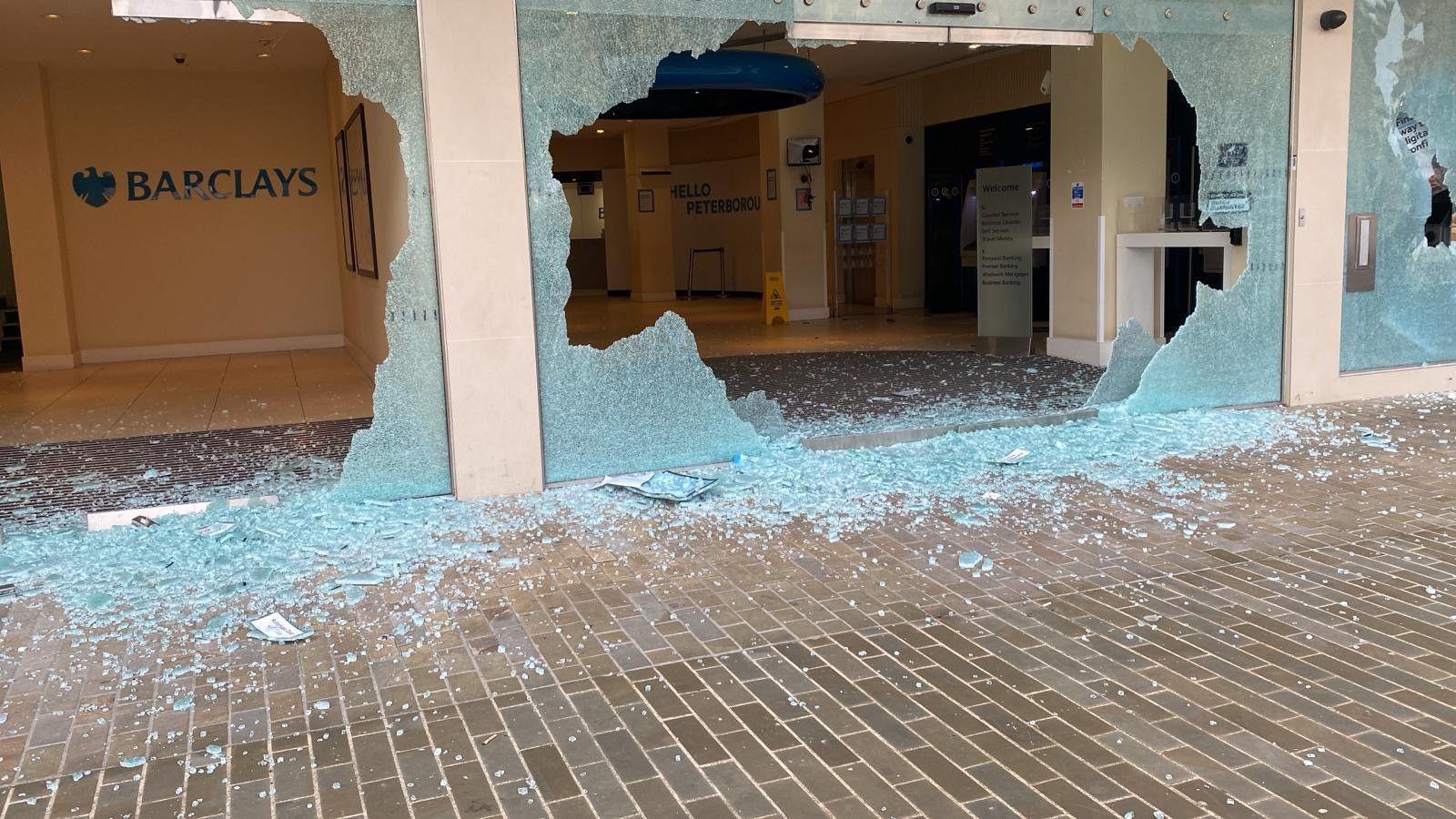 Smashed up shop front of Barclays Bank