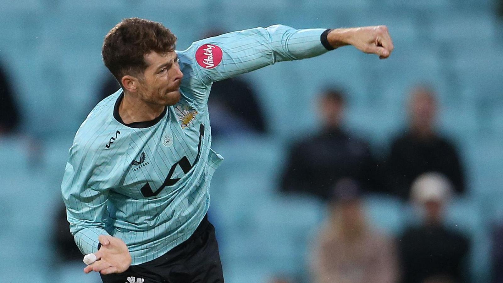 Mitchell Santner bowling for Surrey