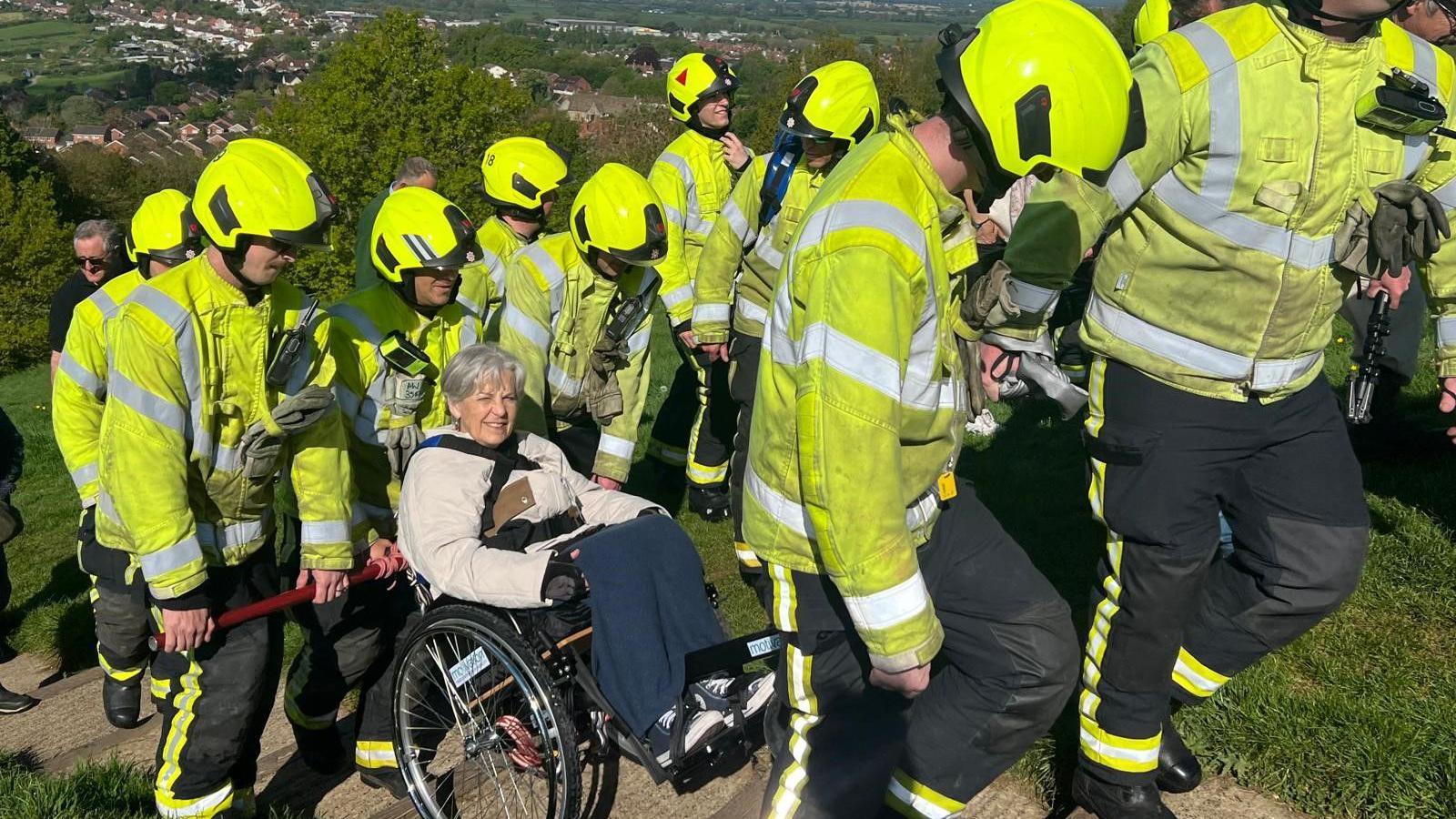 Ms Maw being helped up the hill