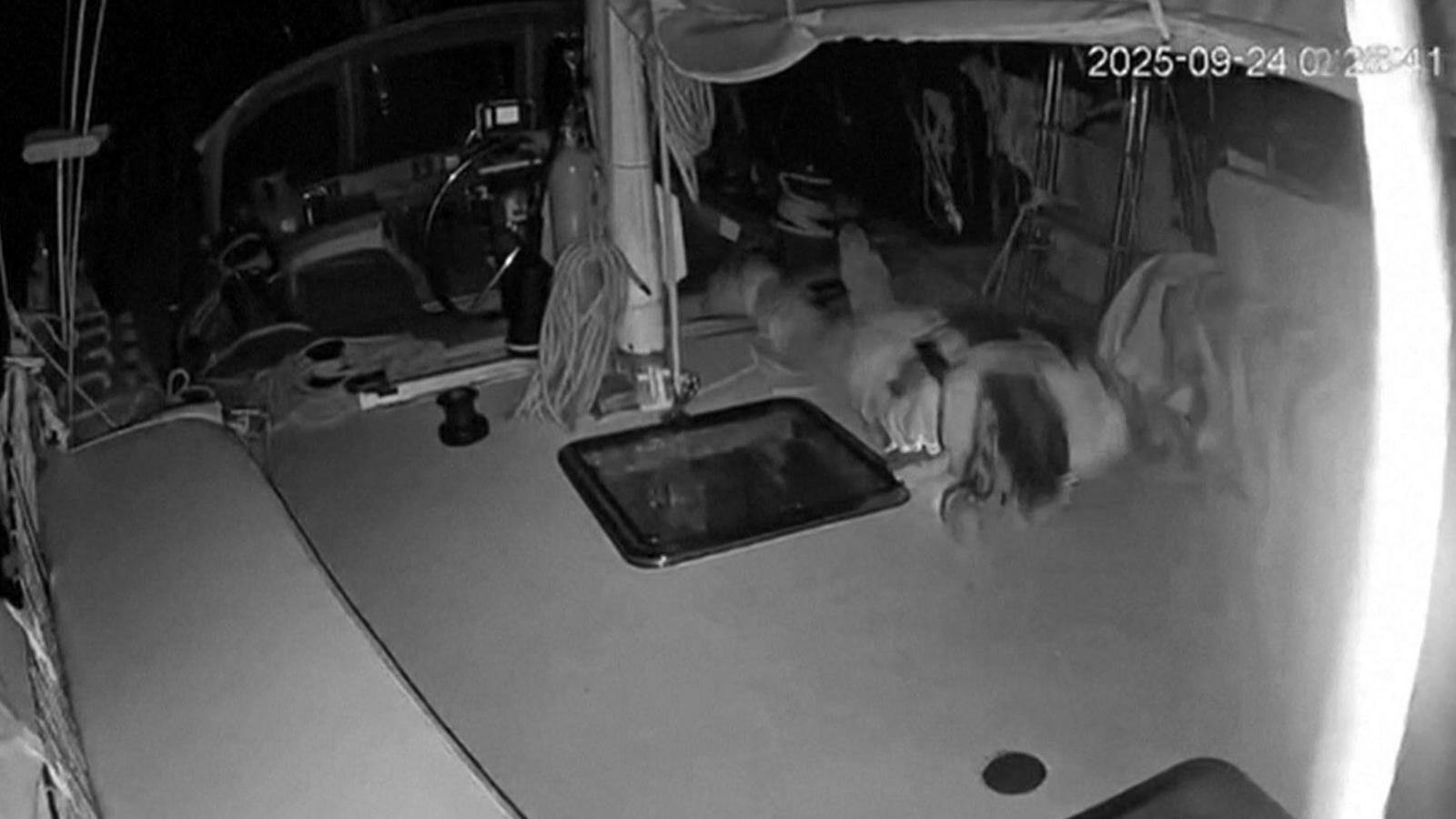 Screengrab of video footage released by the Global Sumud Flotilla (GSF) purportedly showing a man diving for cover after a drone attack on a Gaza-bound vessel off the coast of Crete (24 September 2025)