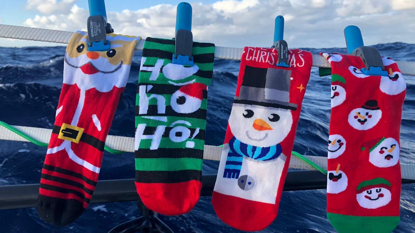 Ambell i hosan Nadolig ar y cwch