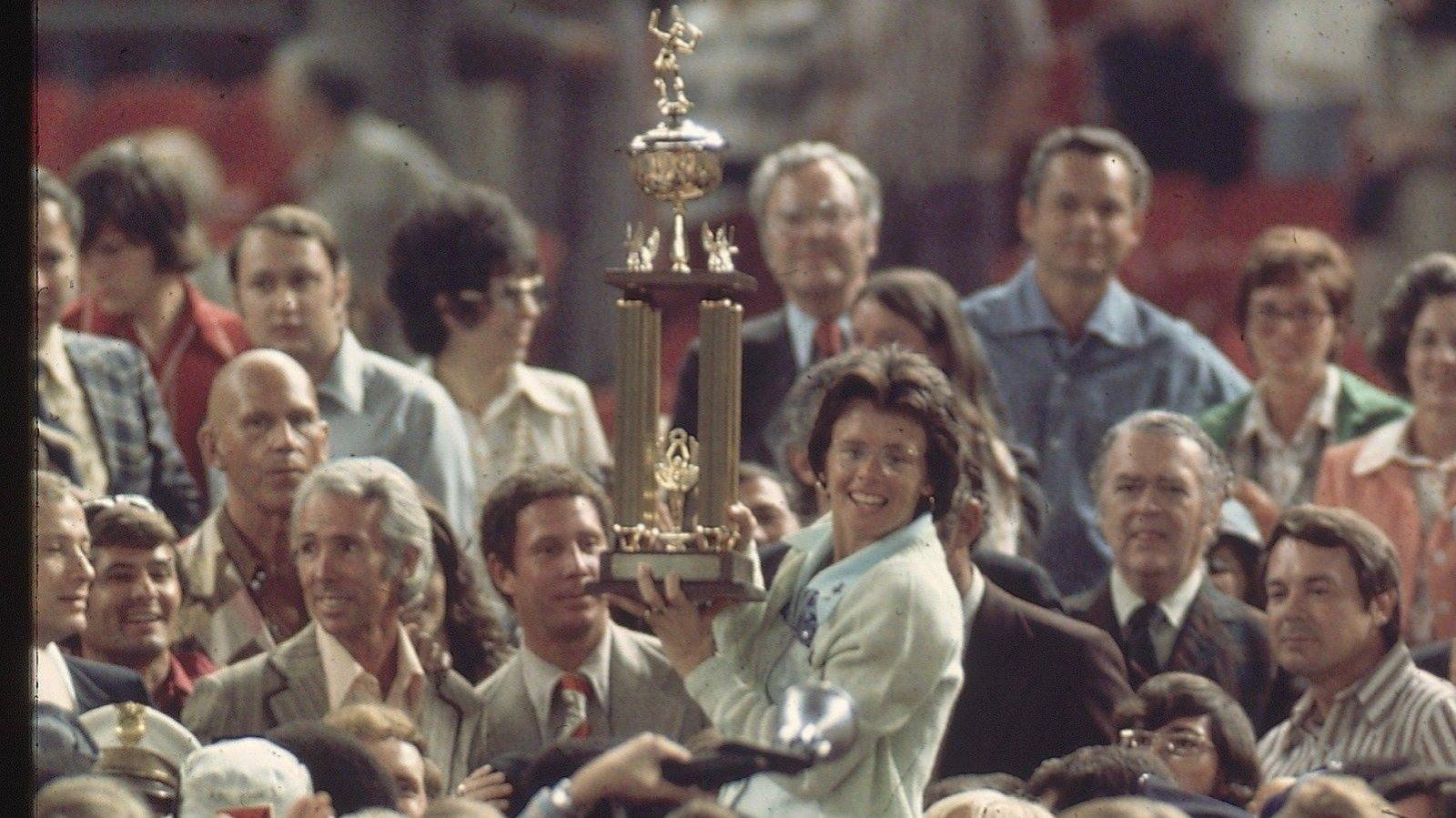 Billie Jean King lifts the trophy after beating Bobby Riggs in the Battle of the Sexes