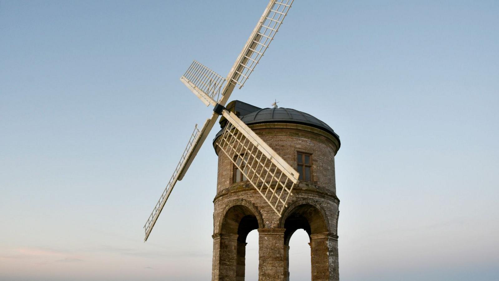 A photograph of Chesterton Windmill with four white sails.