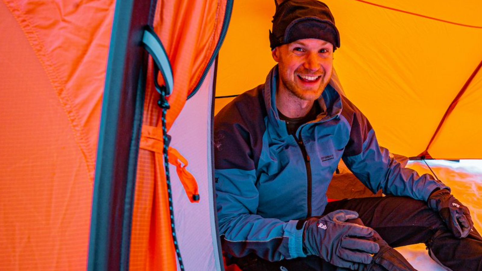 Sam sat in his tent in snowy conditions