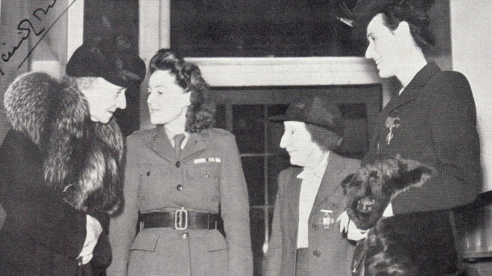 A black and white photograph showing four women wearing George Crosses pinned to their jackets. Miss Townsend is third from the left and is smaller than the other women. She is wearing a smart hat and suit.