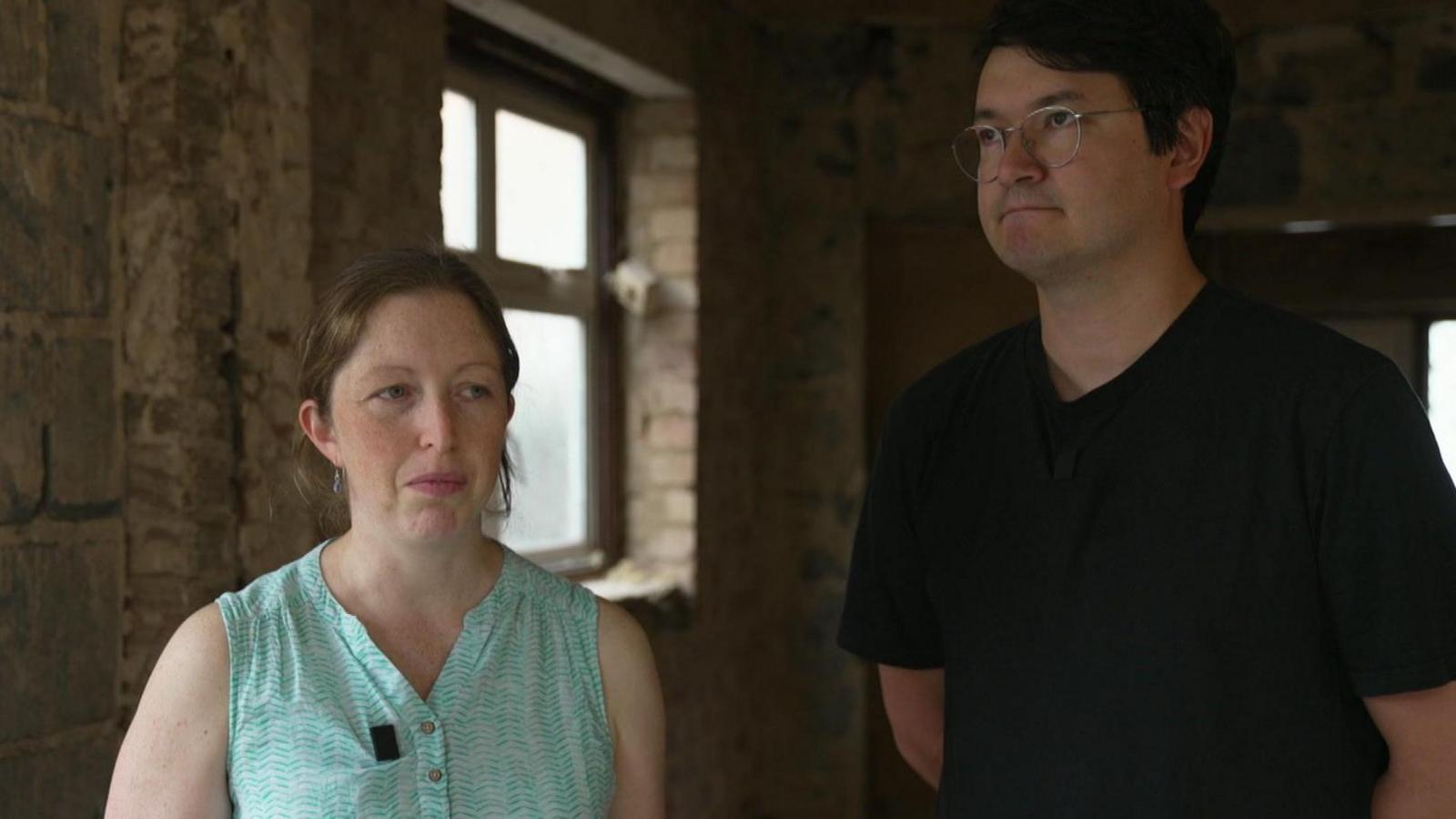 Freya and Alex standing in their home under construction