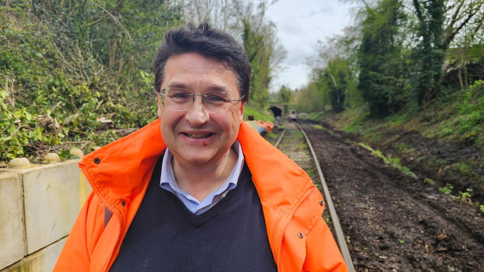 Chairman Neil Ferguson-Lee stands in front of the track which is being repaired