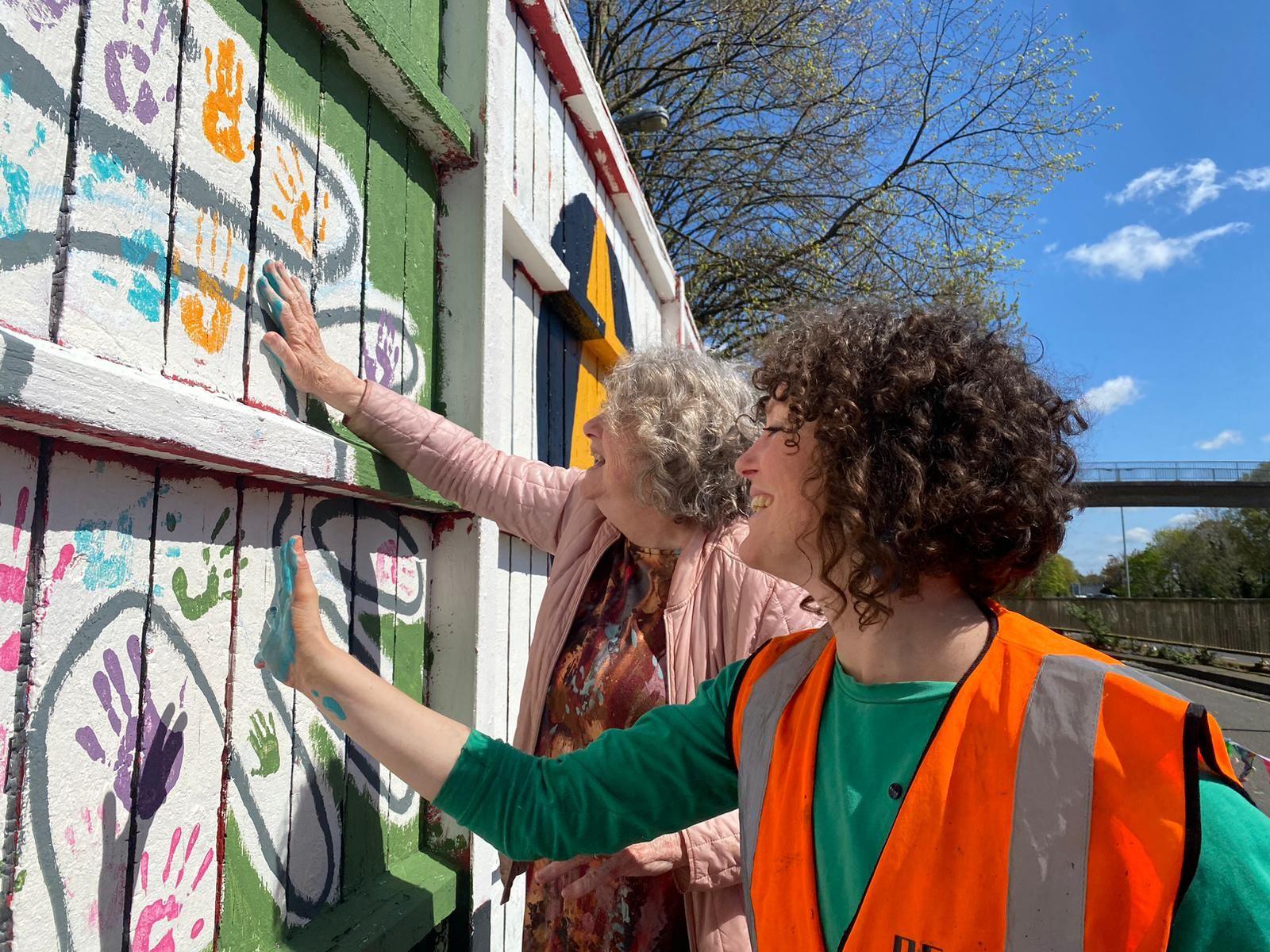 People making hand prints in solidarity with The Value the Caring Economy Alliance project