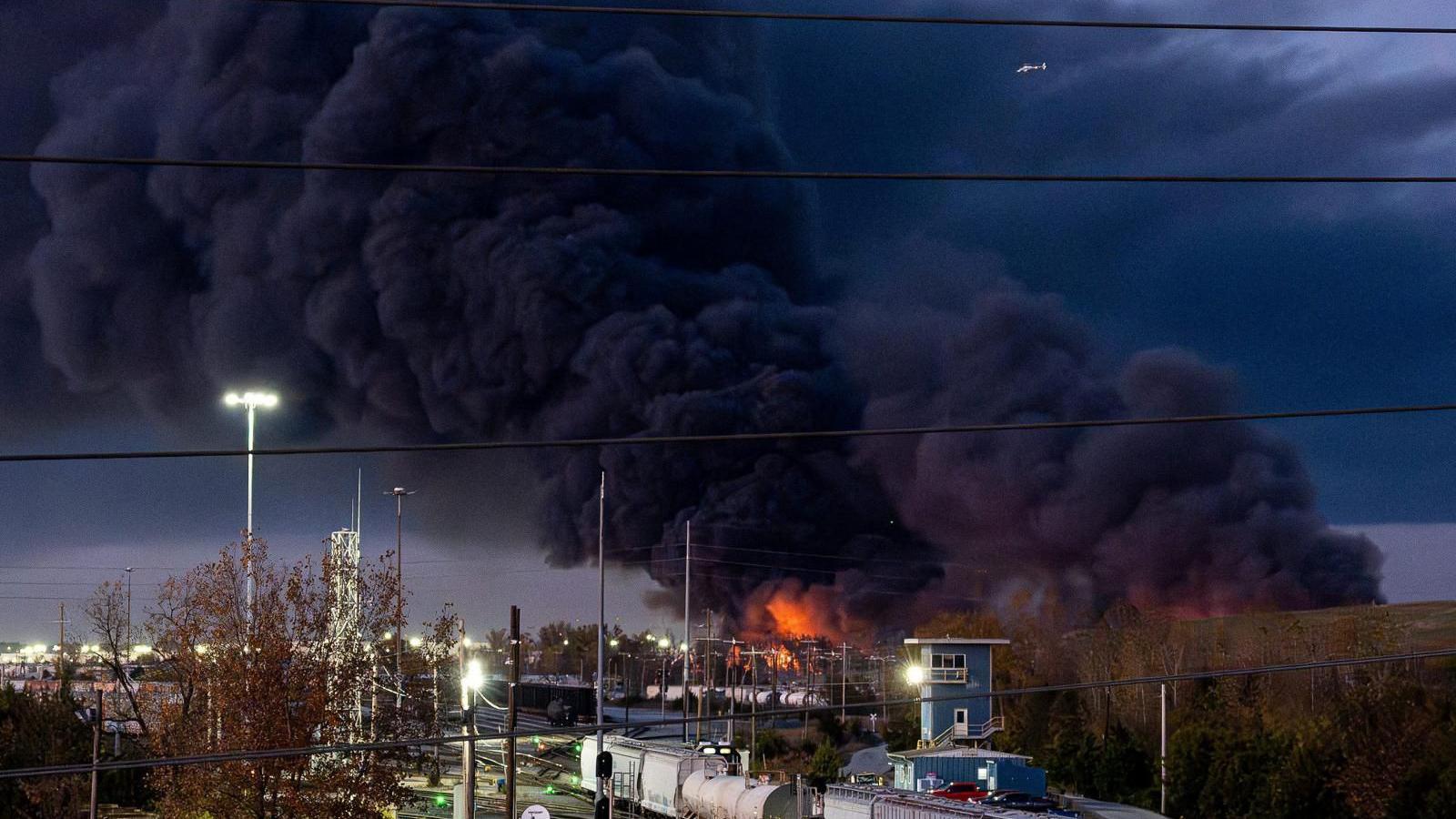 Thick plumes of smoke rise from the crash site.