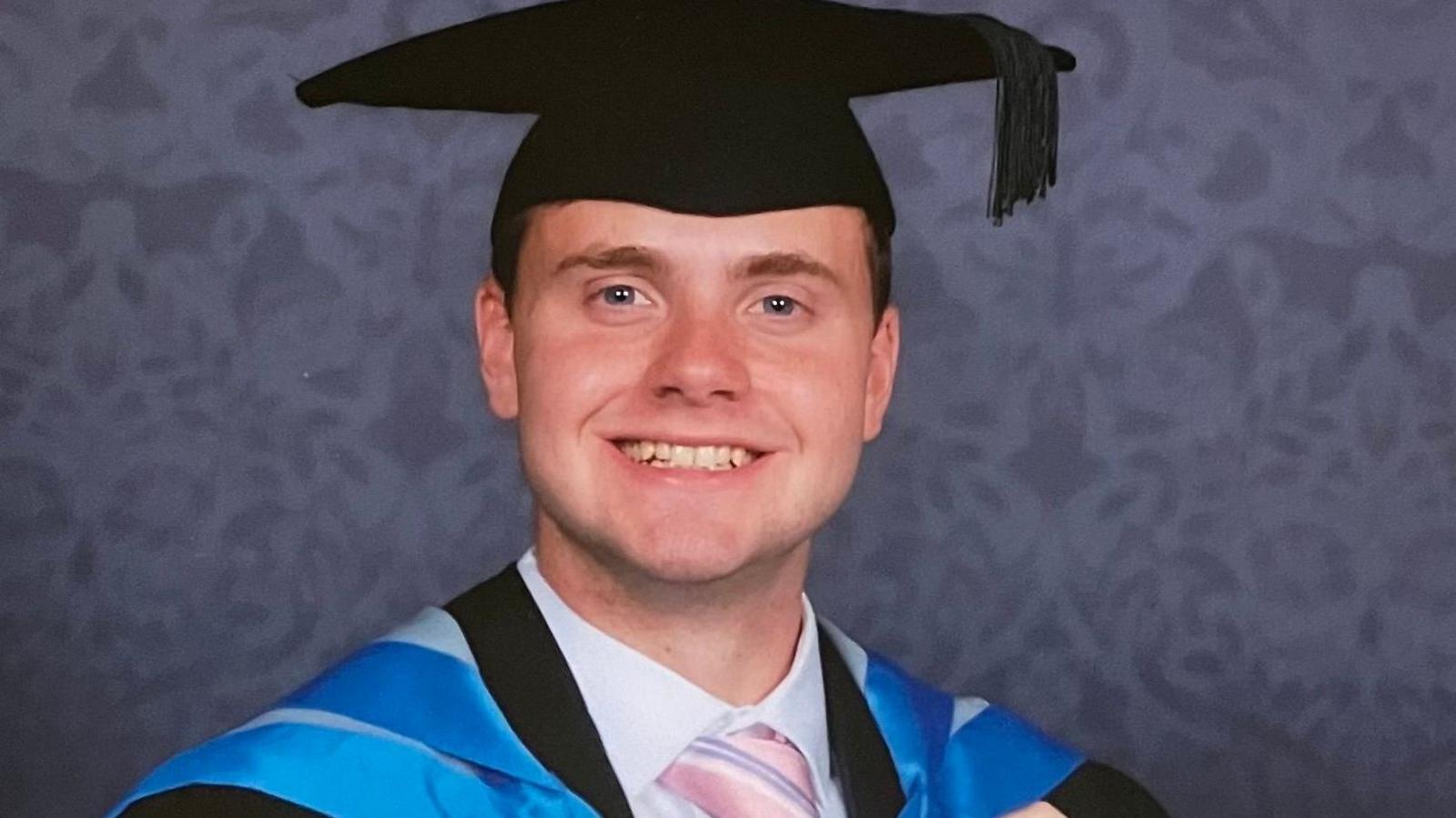 Image of Jack O'Sullivan wearing a university cap and gown