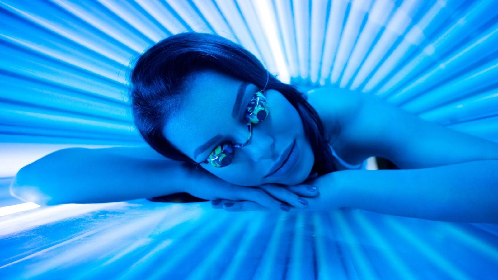 Woman using sunbed (stock photo)