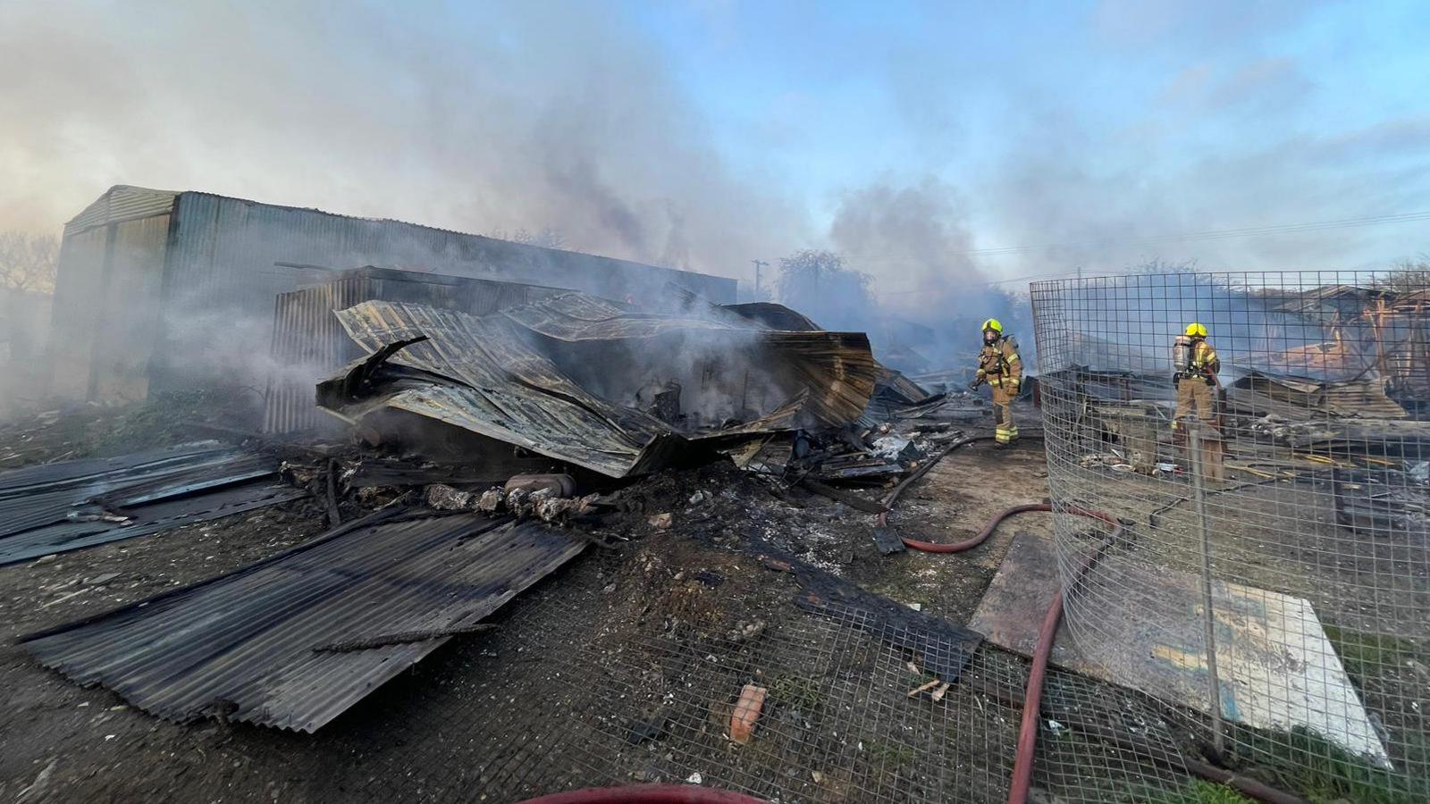 Firefighters at a fire at a  commercial unit in Vicarage Lane West, North Weald, Essex