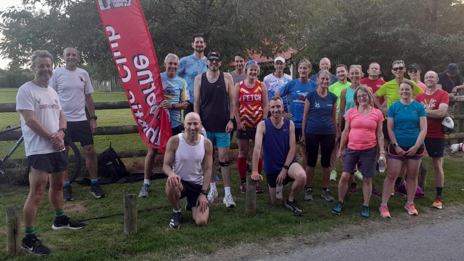 A large group of runners posing for the camera