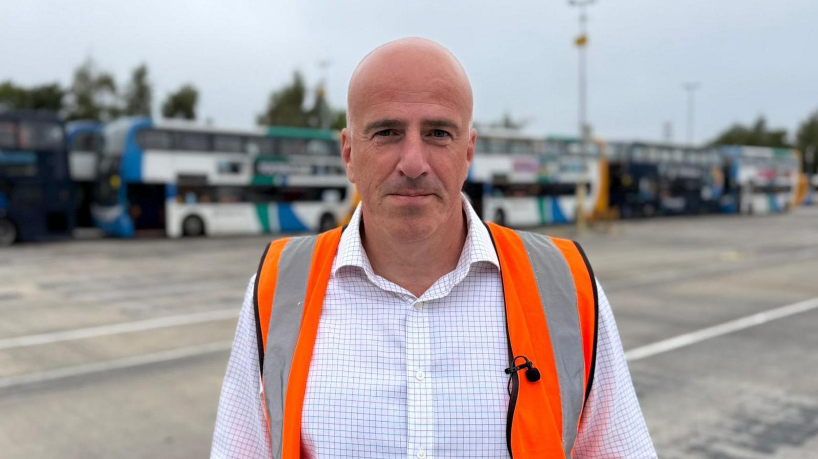 Stagecoach North East managing director Steve Walker, wearing a hi-vis jacket with buses in the background.