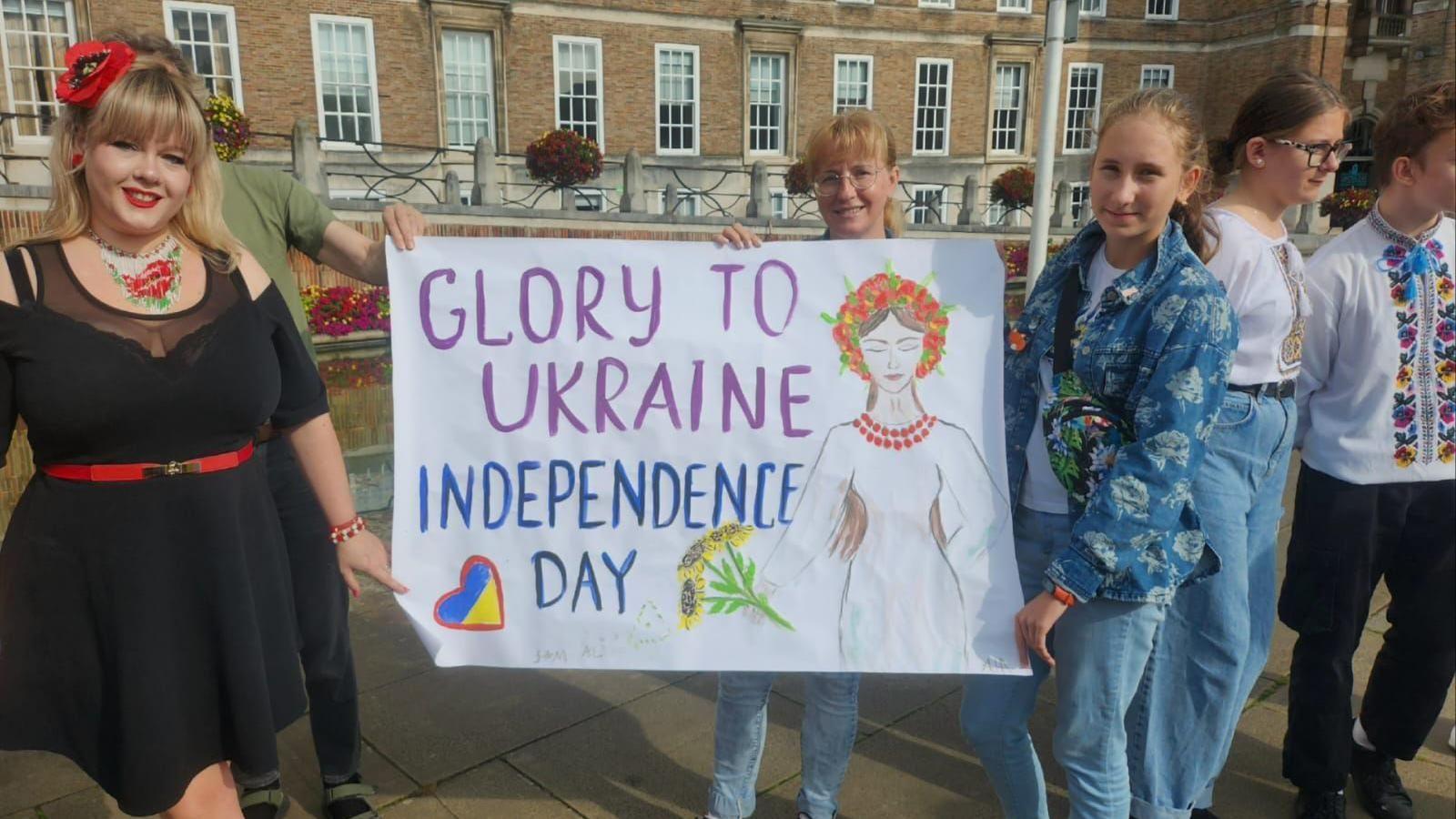 Two women holding a sign that says Glory to Ukraine Independence Day