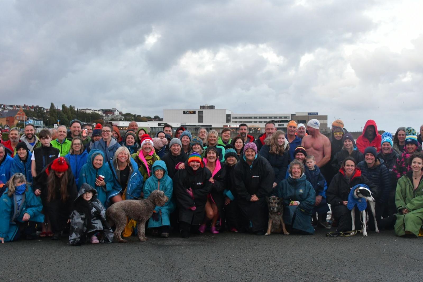 A group of local swimmers smiling together at the rally