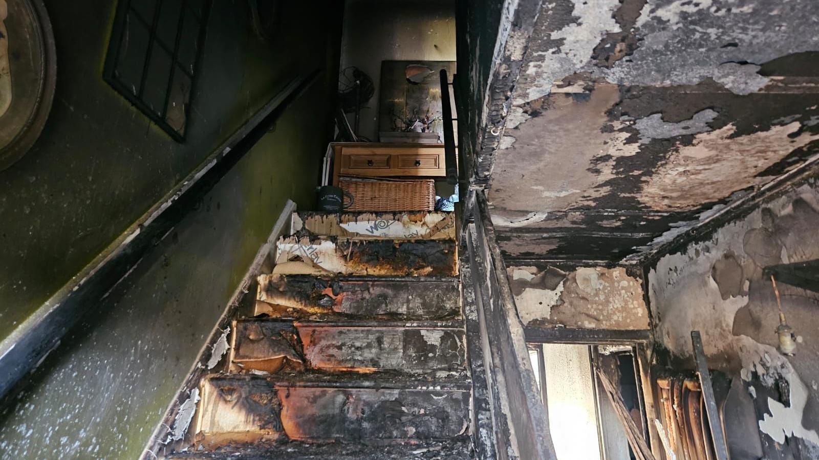 Fire damage to the stairs and the ceiling of the house.