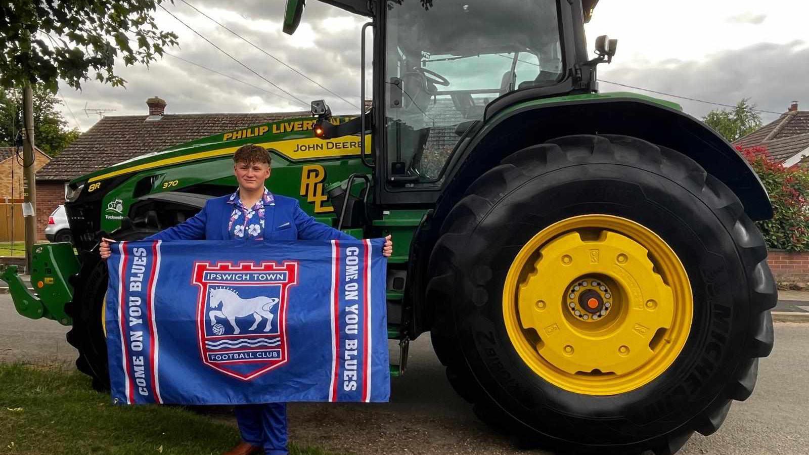 Evan Baldwin in front of a tractor