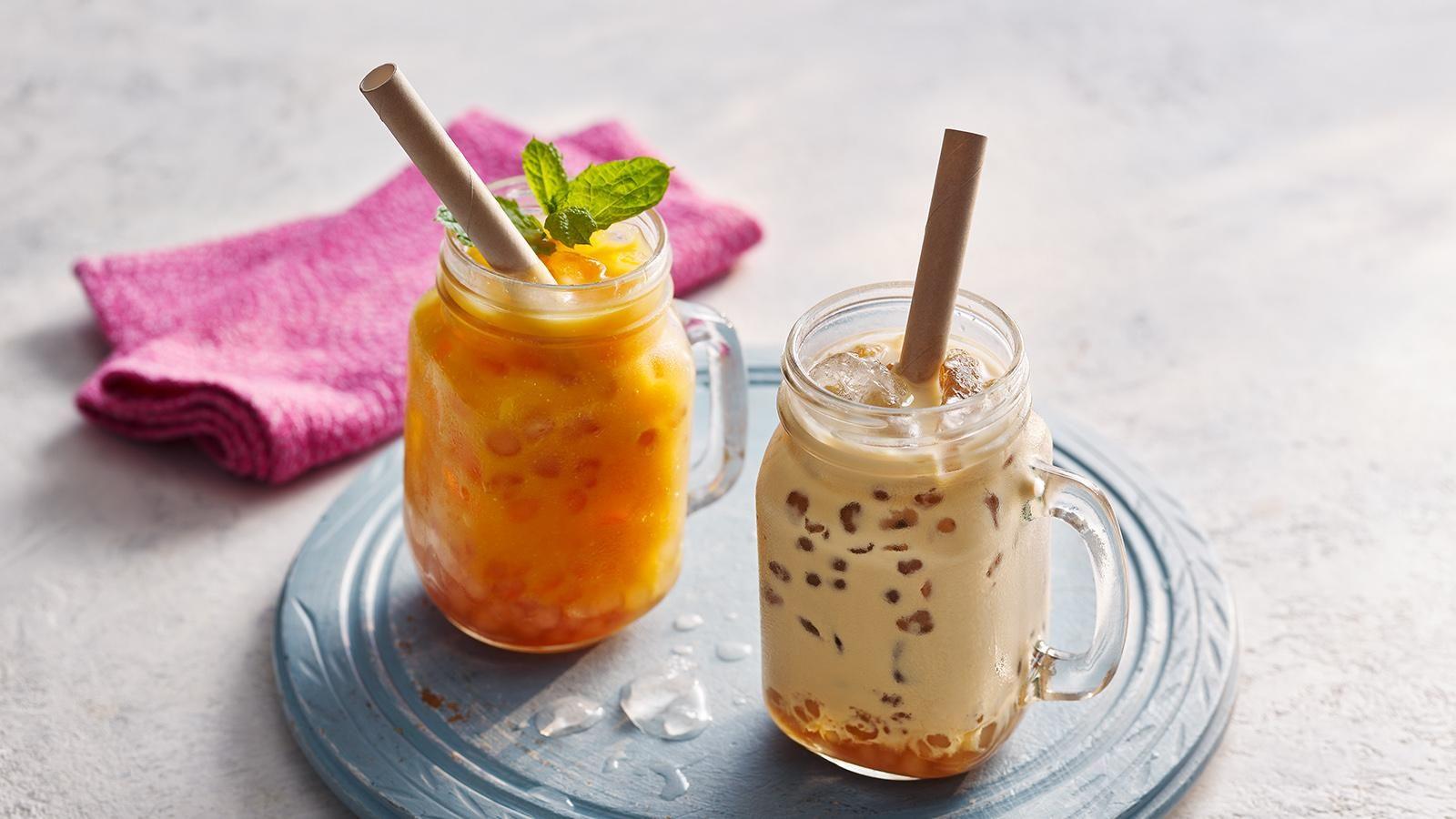 Two big glasses of bubble tea. One classic bubble tea and one fruity bubble tea