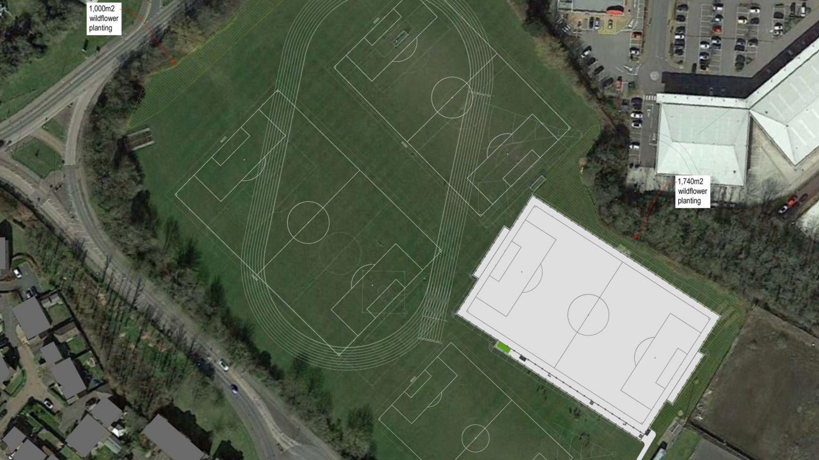 An aerial view of sports pitches with one superimposed in white. 