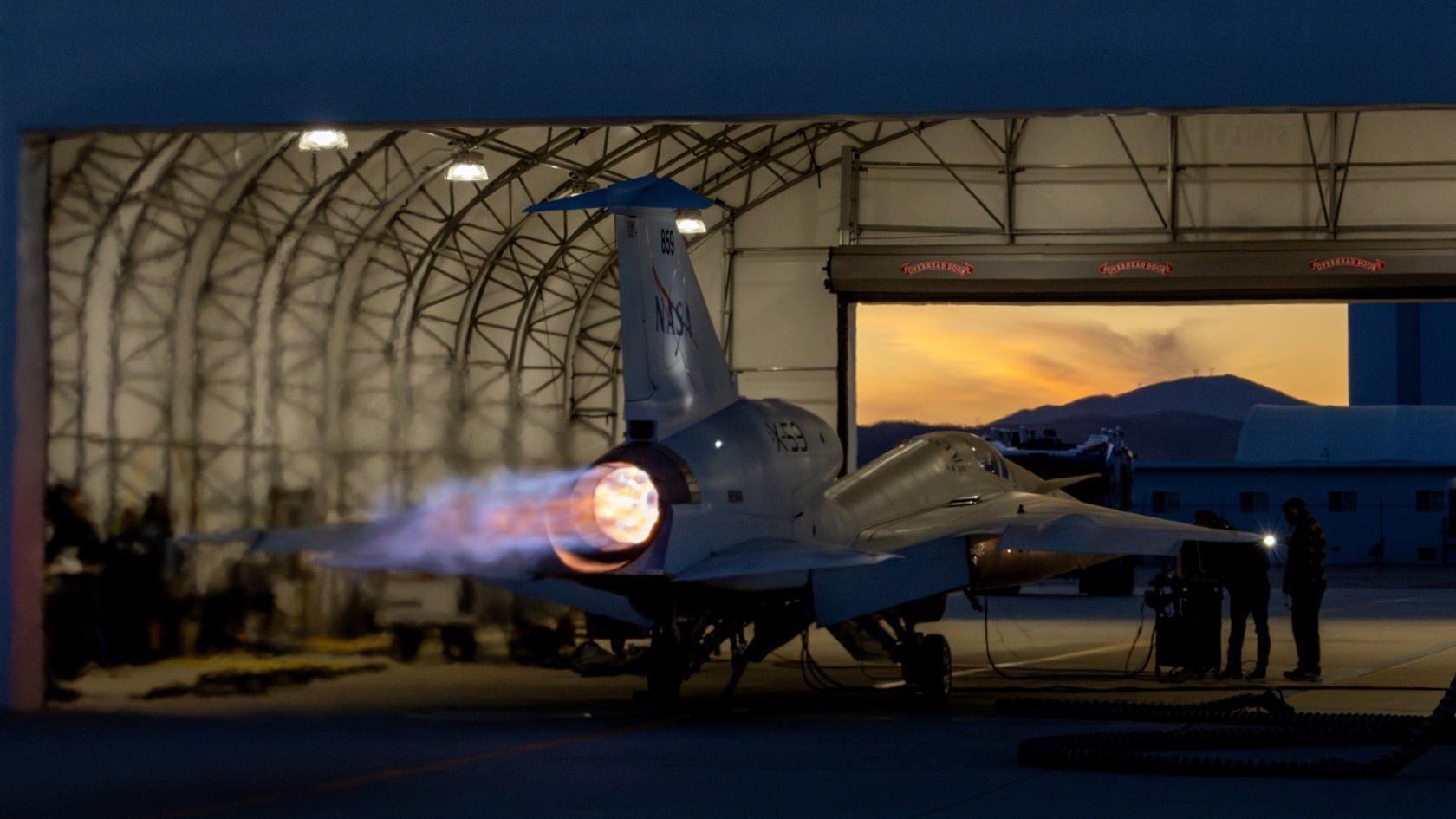 x 59 in a hangar with fire coming from exhaust