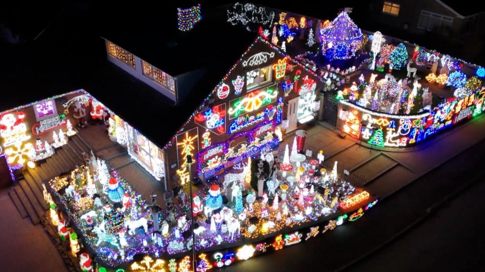A house covered in thousands of Christmas lights.