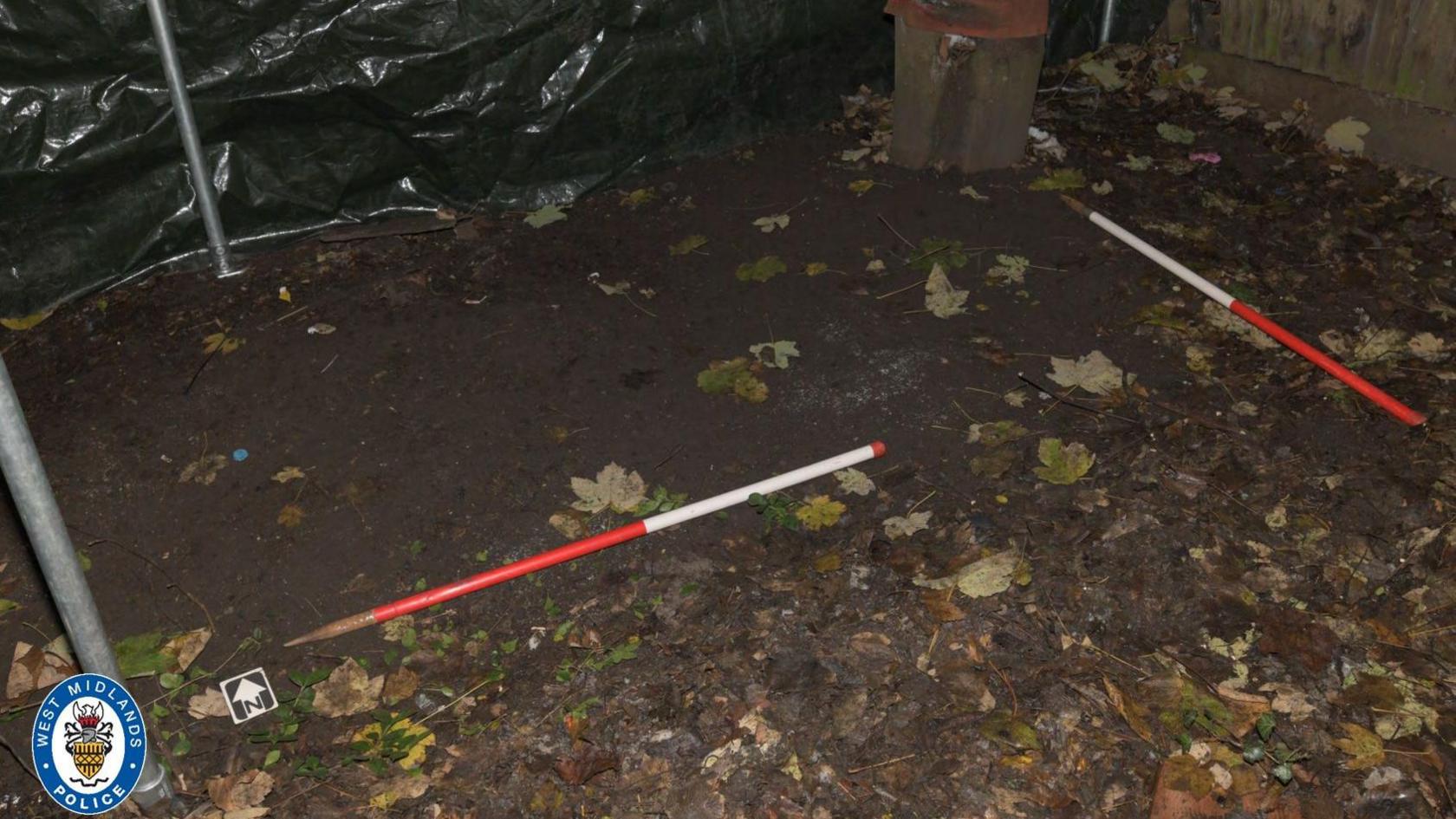 Poles outlining where the body was buried in the garden