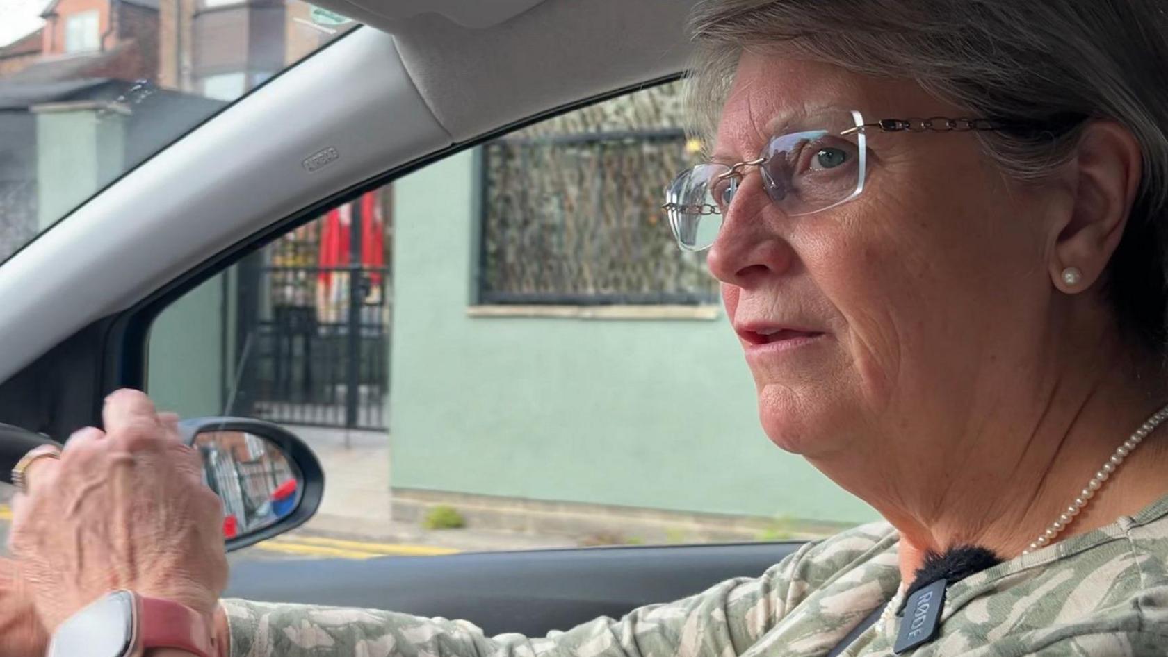 Anita Wilson, driving a van.