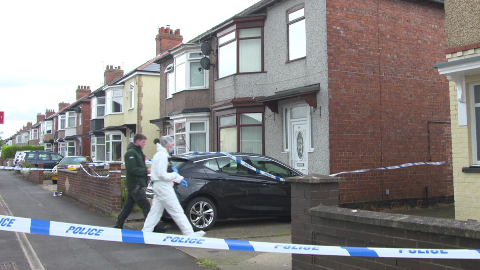 A forensic officer in a white suit walks into the property on Geneva Road, Darlington