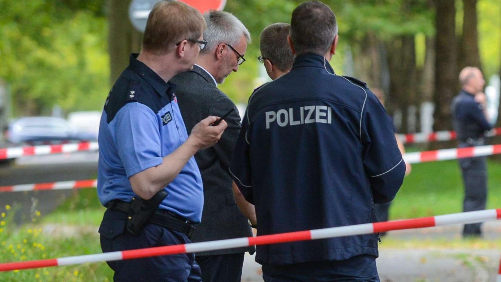 Police investigators secure the scene where officers shot dead an Islamist knifeman